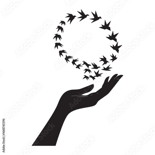 Silhouette of open hand releasing flock of birds into sky flying