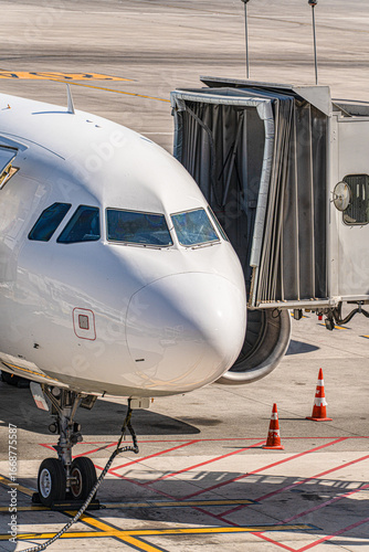 Close-up of an aircraft parked on stand with a jet bridge