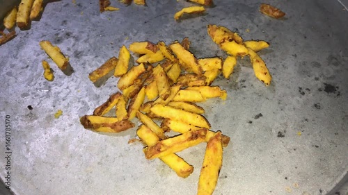 Fried potato sticks on metal surface