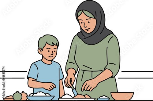 A woman in a black hijab and green tunic preparing food with her young son in a blue shirt.