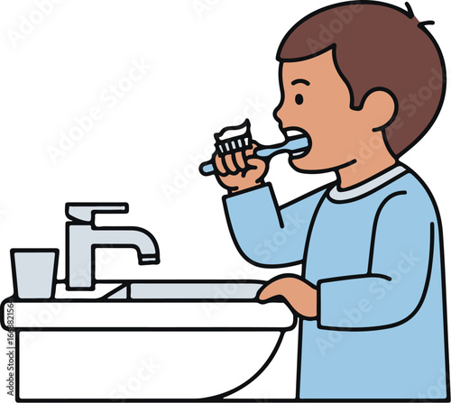 A young boy with brown hair in a light blue shirt, shown from the side, brushing his teeth with toothpaste.