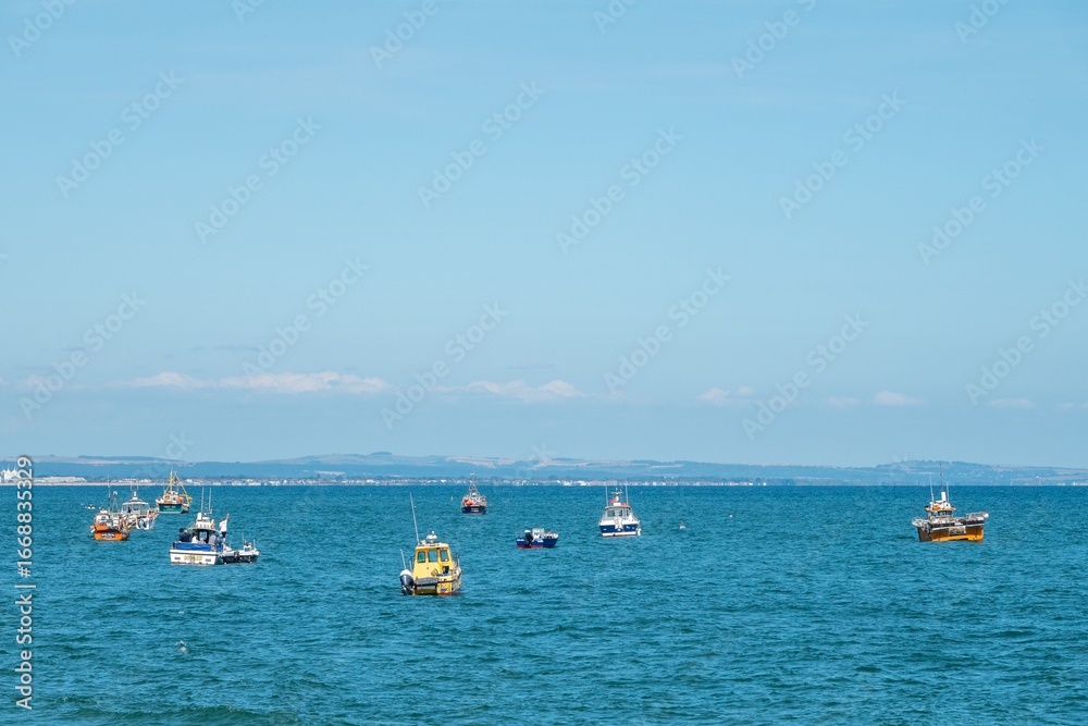 Obraz premium Selsey England - August 24 2025: fishing boats in the sea at Selsey West Sussex