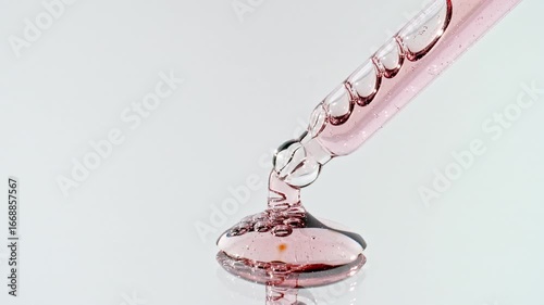 Drops of Essential Oil, Cosmetic Serum Fluid Gel With Molecule Bubbles Spreading From a Glass Pipette. Dermatology science laboratory. Macro Shot of Organic Skin or Body Care Products. High quality 4k
