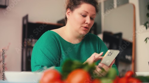 Woman using calorie calculator on phone, searching for healthy diet recipes