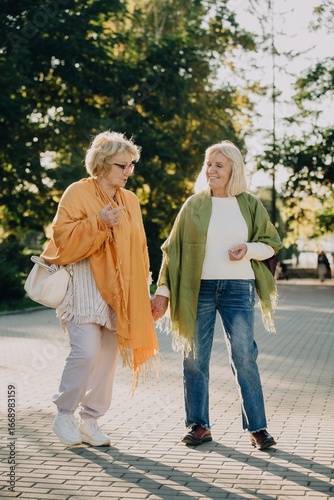 Wallpaper Mural Two senior women holding hands and walking in the park Torontodigital.ca