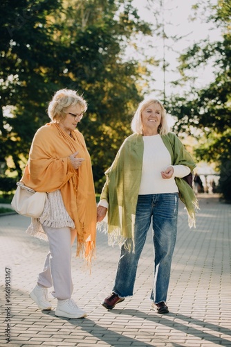 Wallpaper Mural Two senior women holding hands and walking in a park Torontodigital.ca