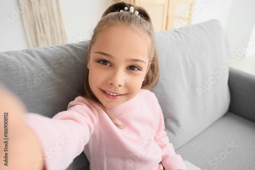Cute little girl taking sel...