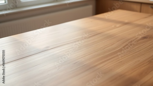 A wooden table showcases subtle grain patterns under soft, gradient kitchen light.