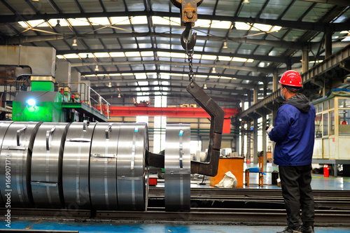 Workers on the production line of the strip steel coil factory are working