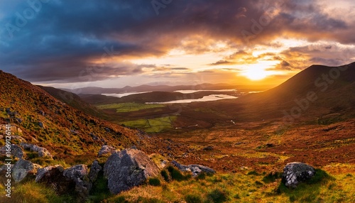 beautiful sunset with dramatic sky at golden hour over the foothill of carrauntoohil mountain macgillycuddys reeks mountains ring of kerry ireland