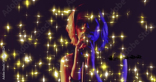 Obraz na płótnie Singing teenage girl wearing sleeveless top on stage, holding microphone amid go
