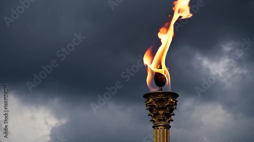 symbolic flame of achievement and honor blazing against backdrop of nebulous skies