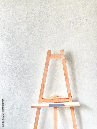wooden easel with blank canvas