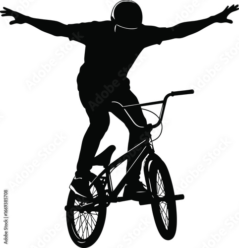 Dynamic silhouette of freestyle biker performing trick with open arms