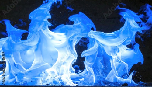 Abstract blue flames dance in swirling patterns against a dark background