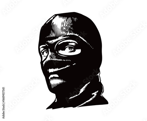 A masked individual stares directly with an intense expression, wearing black clothing that covers the head and face.