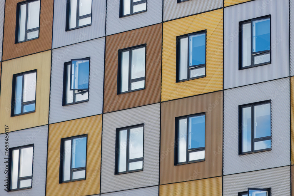 Fototapeta premium Colourful facade of a residential building in the morning, symbolising the real estate market, rentals, market shifts, demographics, and demand.