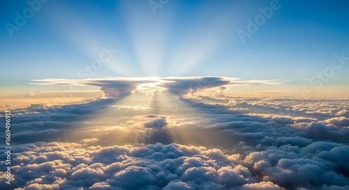 Obraz na płótnie Sunbeams breaking through clouds from above the sea of clouds