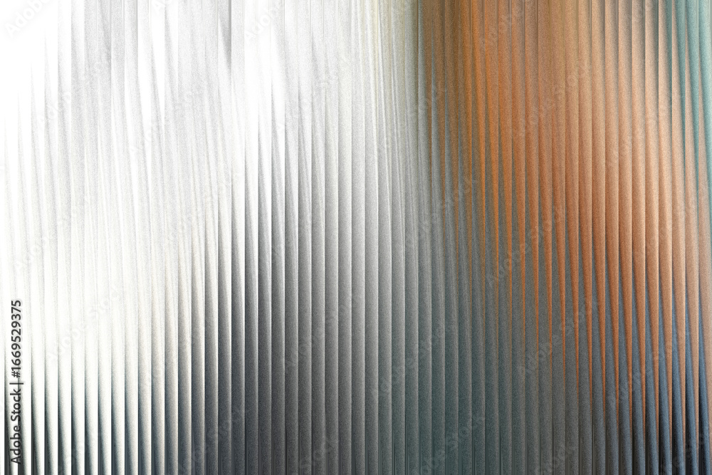 Obraz premium A textured surface with vertical ridges, transitioning from bright white and silver on the left to warm brown and cool blue tones on the right, creating a visually dynamic abstract background