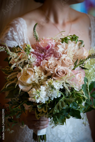 Bride Holding Lush Romantic Bouquet in Soft Lighting