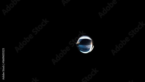 Floating Droplet Against Black Background