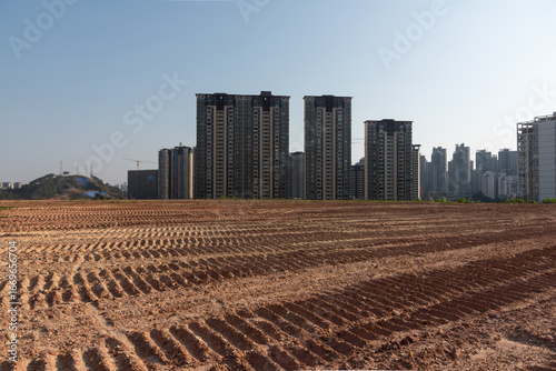 Vászonkép The undeveloped large roadbed and pavement with high-rise residential buildings in the distance in China
