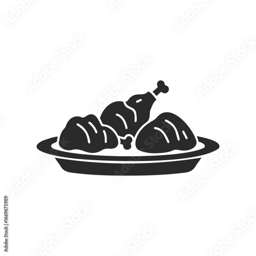 Silhouette of roasted chicken drumsticks and thighs on plate