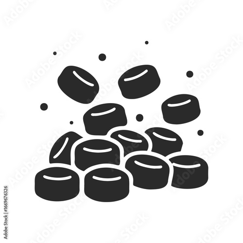 Black hockey pucks falling on a stack isolated on white background