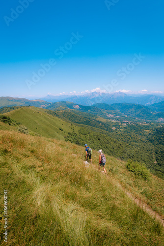 Couple of hikers admiring alpine mountain view, Monte Palanzone