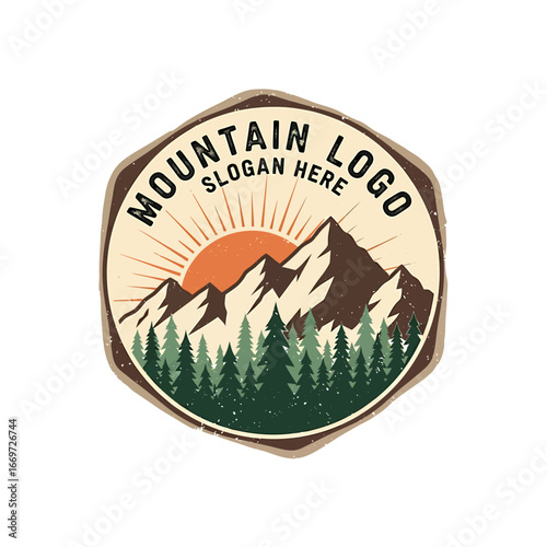 Vintage style logo featuring snow-capped mountains, a rising sun, and a dense forest of evergreen trees, framed in a rustic hexagon.
