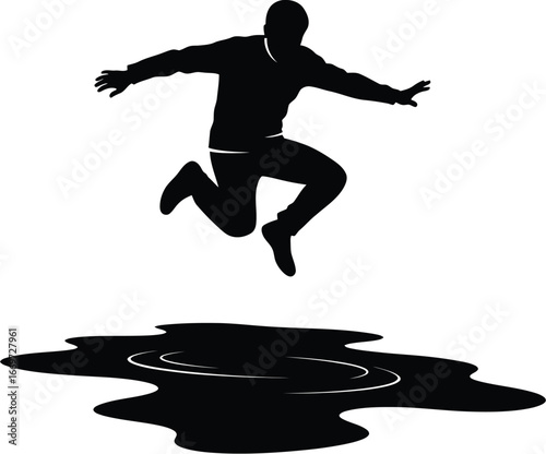 Silhouette of a man jumping over a puddle, creating a splash, a dynamic action shot with reflection