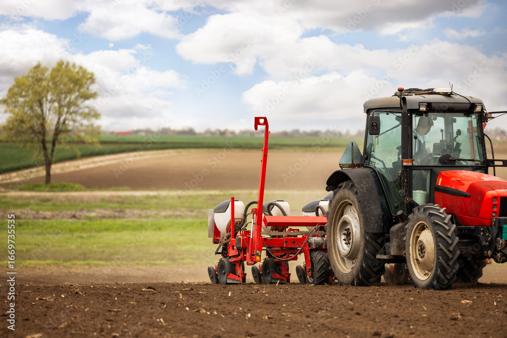 Obraz premium Tractor and seeder for sowing corn