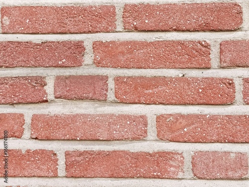 Red brick wall with contrasting light gray mortar architectural background