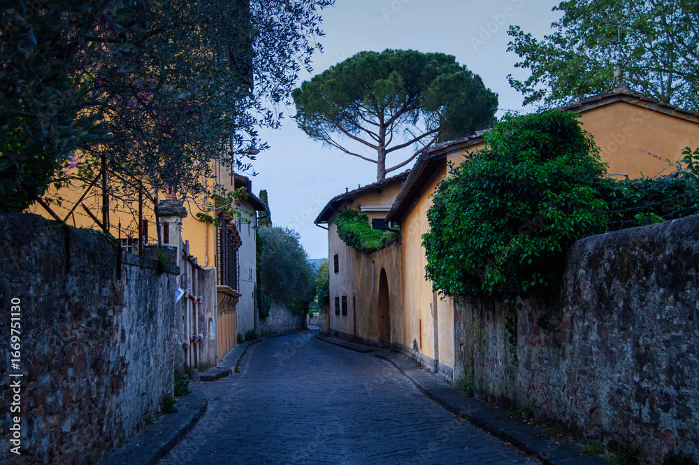 Fototapeta premium Empty narrow street of the old district of Florence the evening