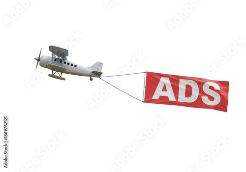 Isolated vintage biplane pulling red banner with word Ads against the sky, aerial advertising