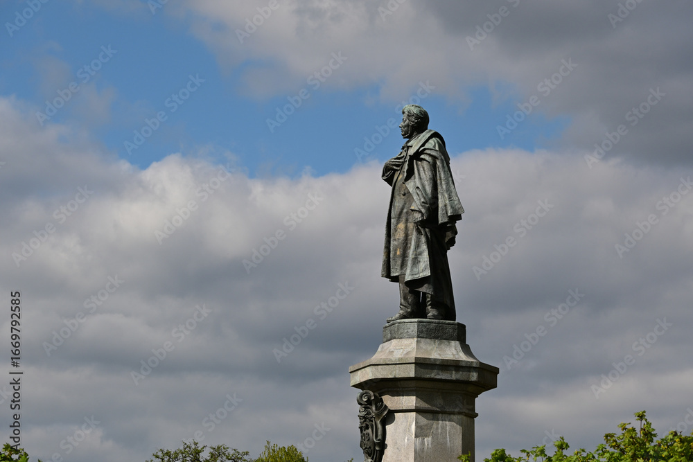 Fototapeta premium The statue of Adam Mickiewicz. Monument dedicated to Adam Mickiewicz at the Krakowskie Przedmiescie in Warsaw, Poland. Closeup view