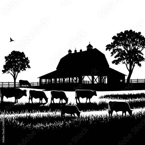 Silhouette of cows grazing in a field with a barn and trees behind
