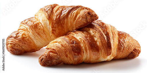 Two golden brown flaky croissants piled together isolated on white background