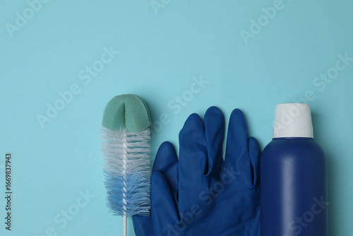 cleaning product, sponge, gloves on a blue background
