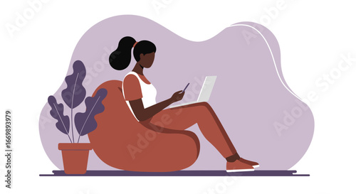 Comfortable Black woman working or studying from home, using laptop and phone. Ideal for remote work, online learning, and modern digital lifestyle concepts.