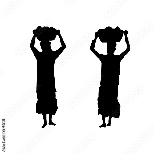 Two women carry baskets on their heads, representing tradition and resilience in silhouette