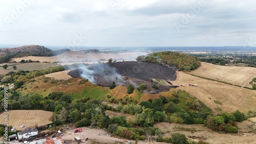 Wildfire burning in Shropshire hills with fire service in attendance. 