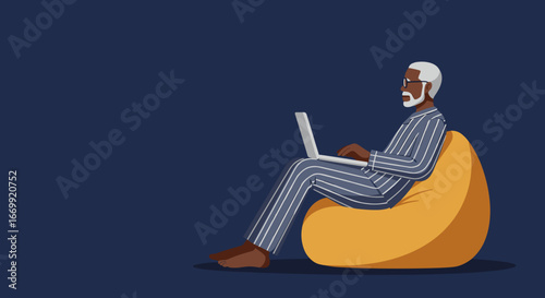 Elderly Black man comfortably working or relaxing on a bean bag chair with a laptop at home, illustrating remote work, leisure, or digital lifestyle.