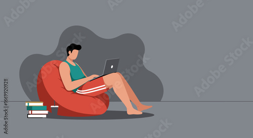 Man comfortably working or studying on a laptop from a red bean bag chair at home, surrounded by books and a drink. Modern remote lifestyle.