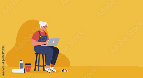 Elderly woman with glasses and overalls sits on a stool, focused on her laptop. Represents learning, remote work, or hobbies for seniors.