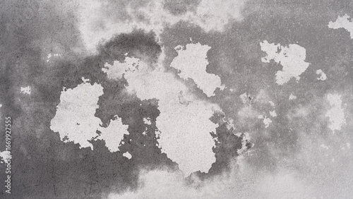 Abstract Gray Wall Texture with White Patches Creating a Distressed Appearance