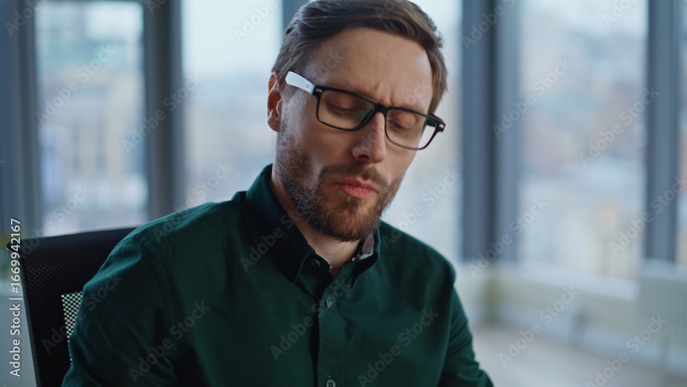Tired employee answering smartphone call in office closeup. Sad manager talking Tired employee answering smartphone call in office closeup. Sad manager talking