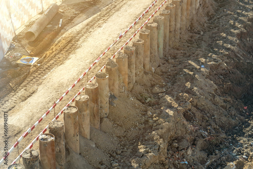 Cuadro en lienzo Overhead view of active construction site featuring sturdy retaining wall made o