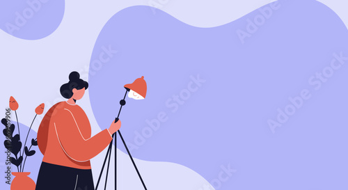 Woman setting up a studio light, representing creativity, design, or a home workspace. Ideal for concepts of inspiration, artistic endeavors, and modern work.