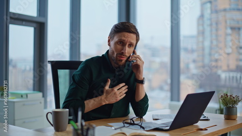 Konstfotografi Business manager concerned call sitting workplace with panoramic window closeup